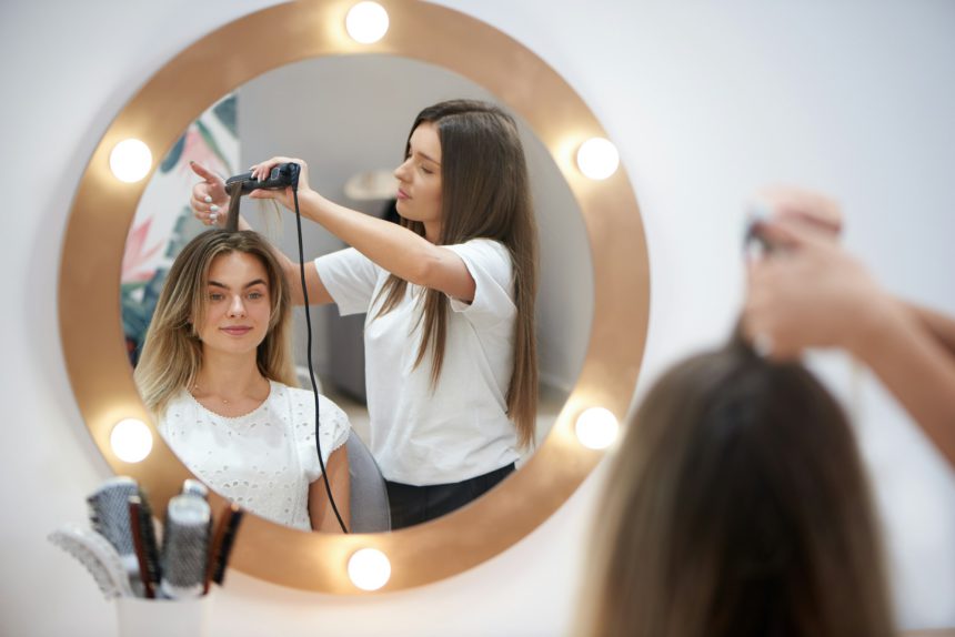 Blonde getting trendy hairstyle in beauty salon