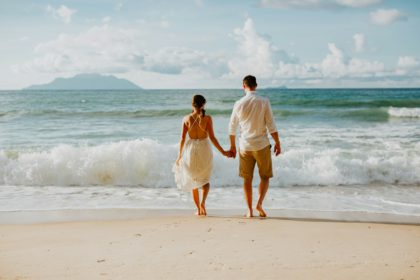 honeymoon wedding couple on beach at sunset