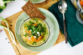 One plate with vegan food, cabbage soup and on the table at home